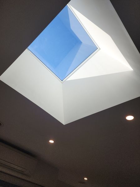 Plastered skylight well with downlights