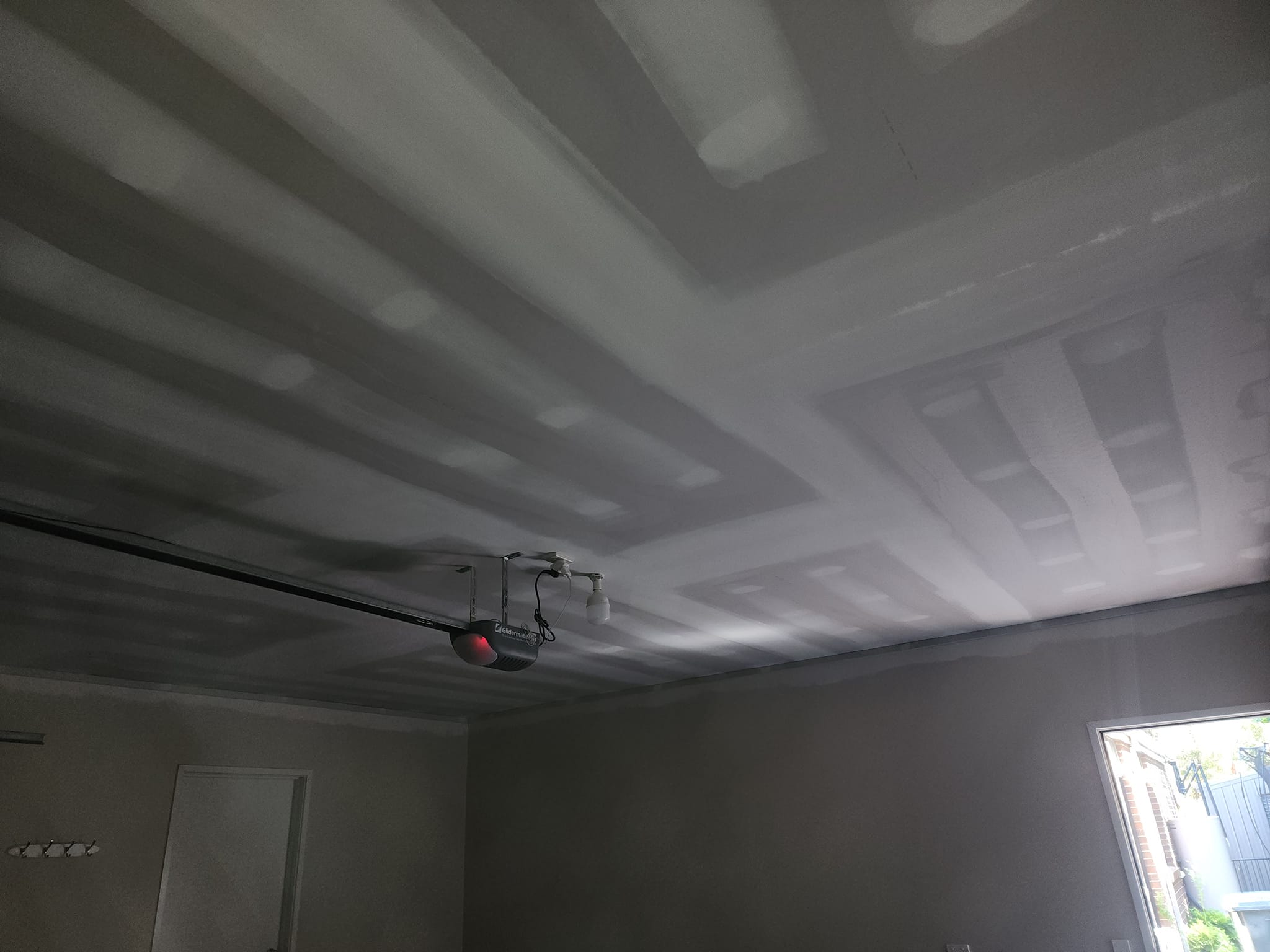 Freshly set garage ceiling with a garage door motor
